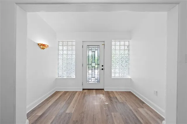 a view of a patio with table and chairs and a barbeque