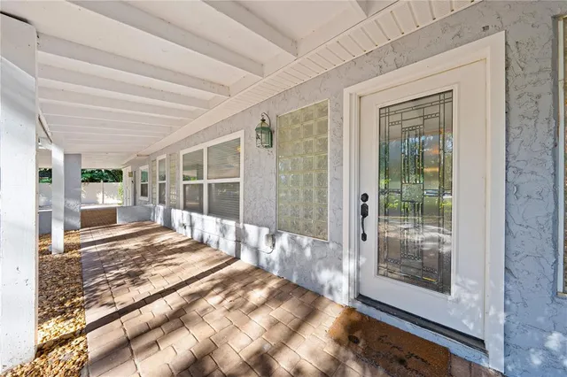 a view of a kitchen with refrigerator and white cabinets