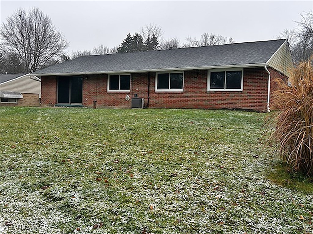 743 Renninger Road Akron, OH 44319 - Photo 2 of 14 Back of property featuring a lawn and central AC