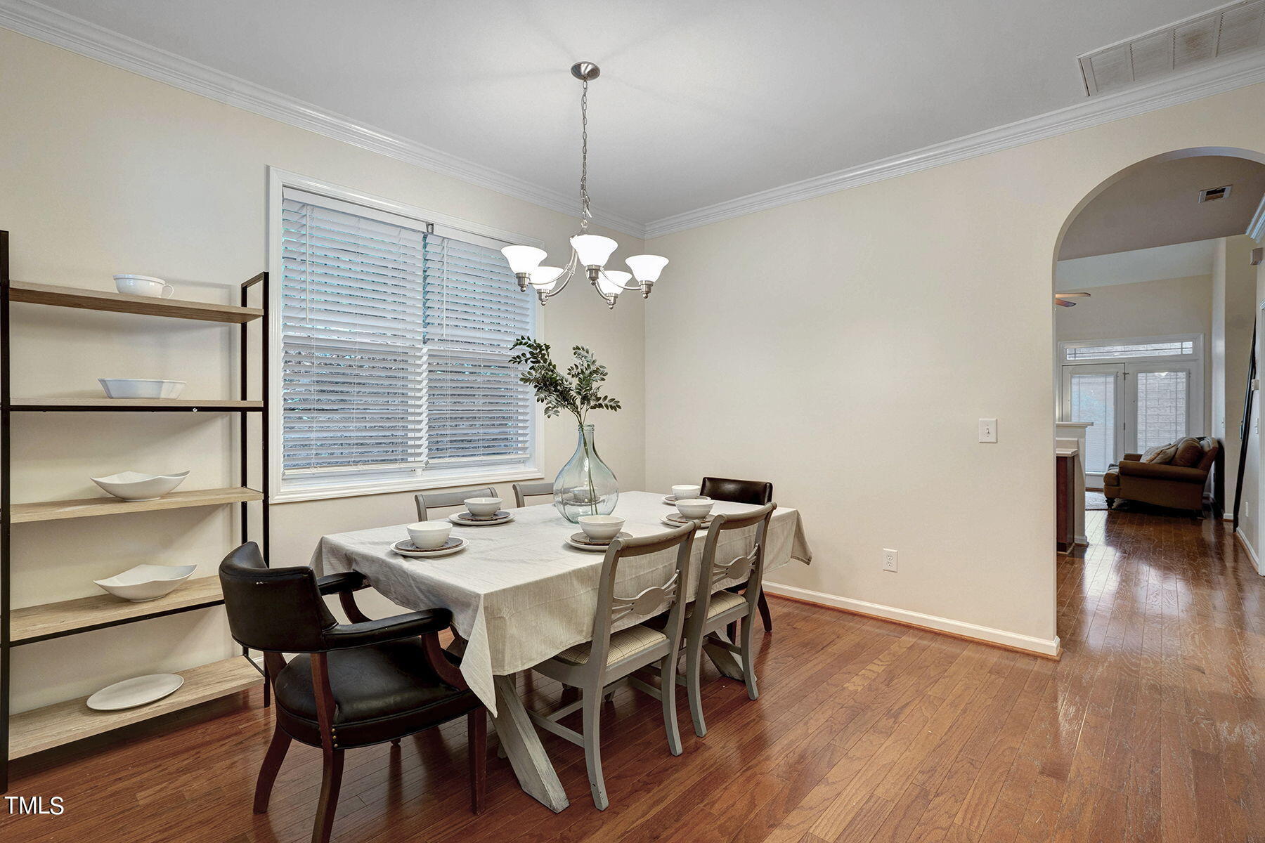 4603 Altha Street Raleigh, NC 27606 - Photo 4 of 27 a dining room with furniture wooden floor a chandelier and a mirror