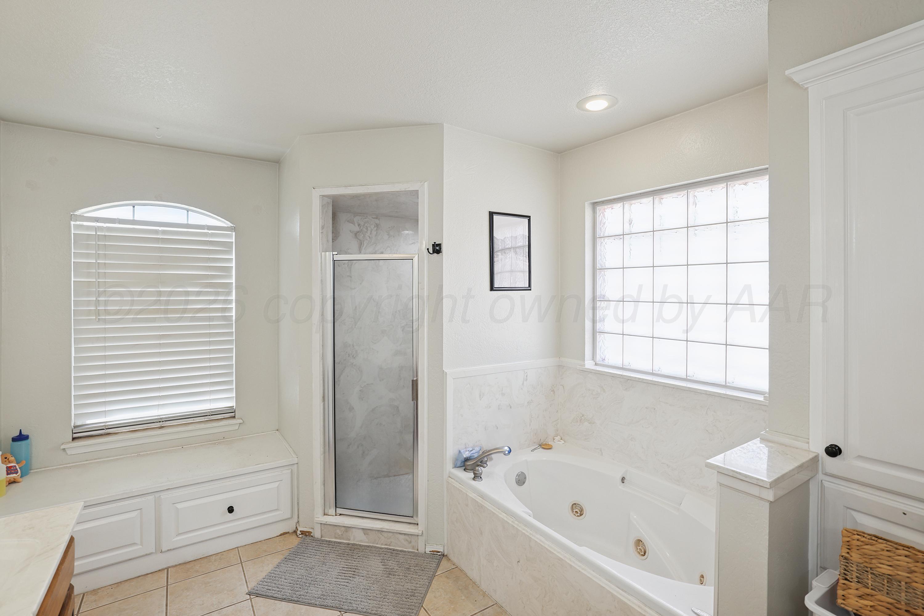 6400 Rally Road Amarillo, TX 79119 - Photo 11 of 21 a bathroom with a bathtub and a shower