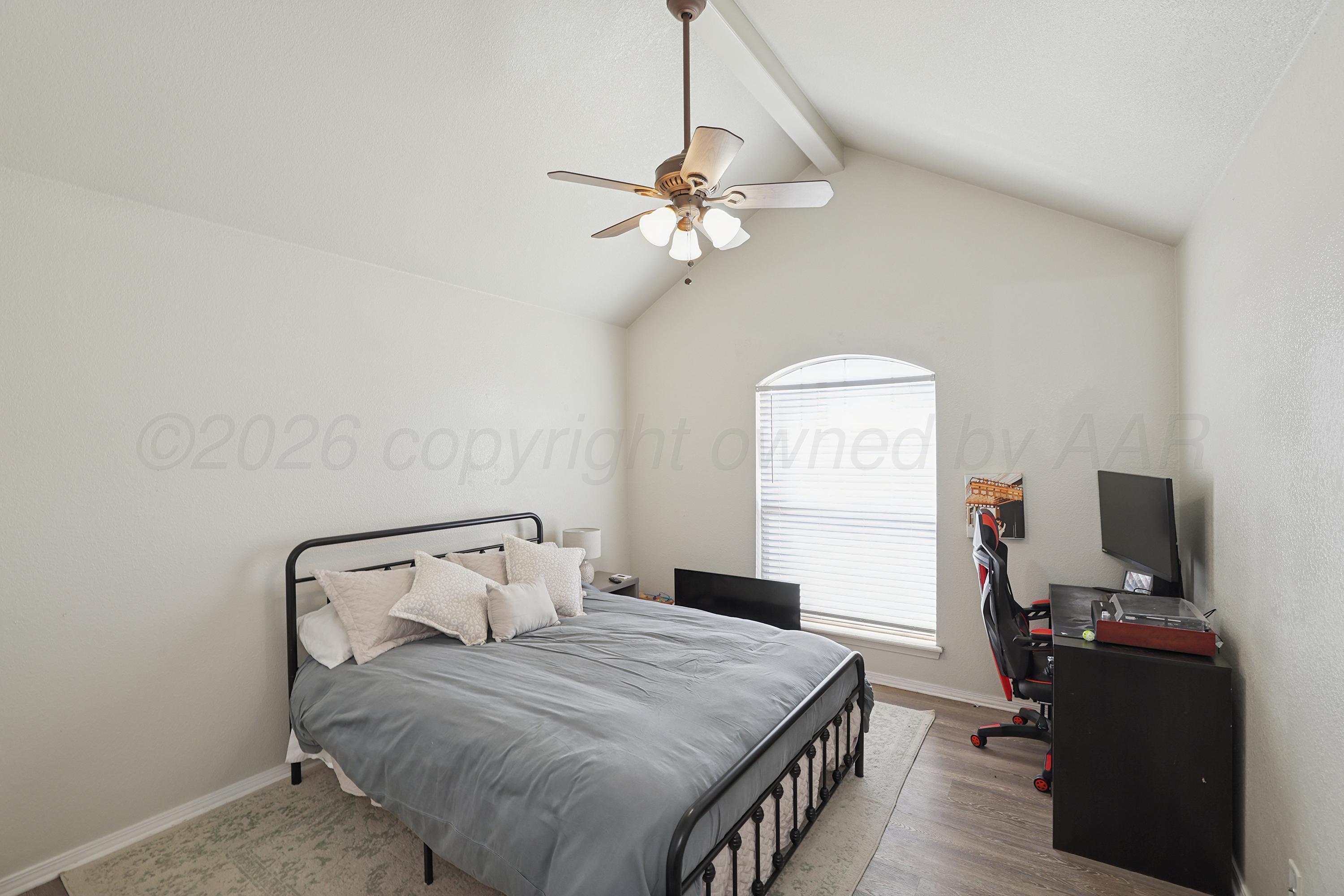 6400 Rally Road Amarillo, TX 79119 - Photo 13 of 21 a bedroom with a bed and a chandelier