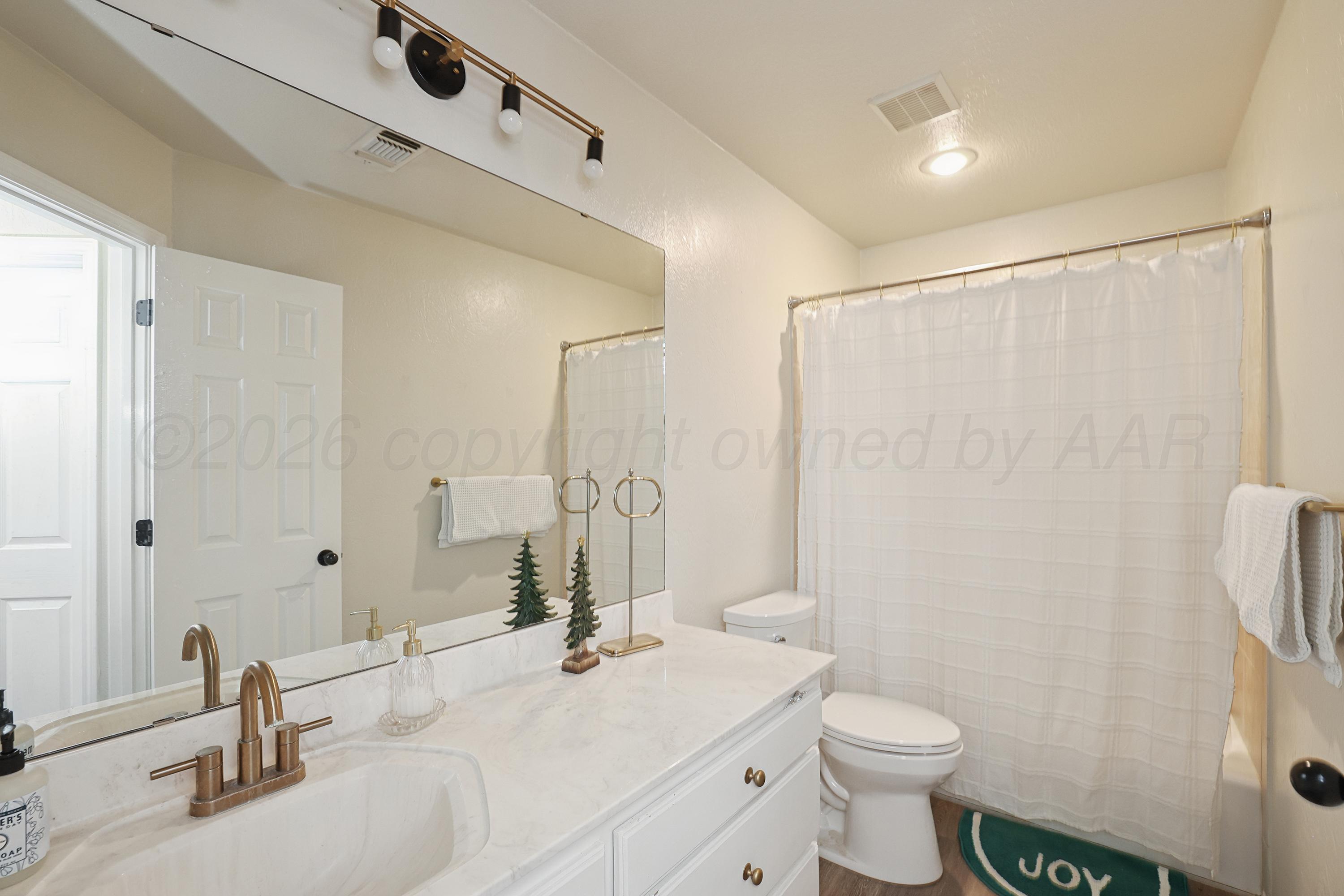 6400 Rally Road Amarillo, TX 79119 - Photo 17 of 21 a bathroom with a sink toilet and shower