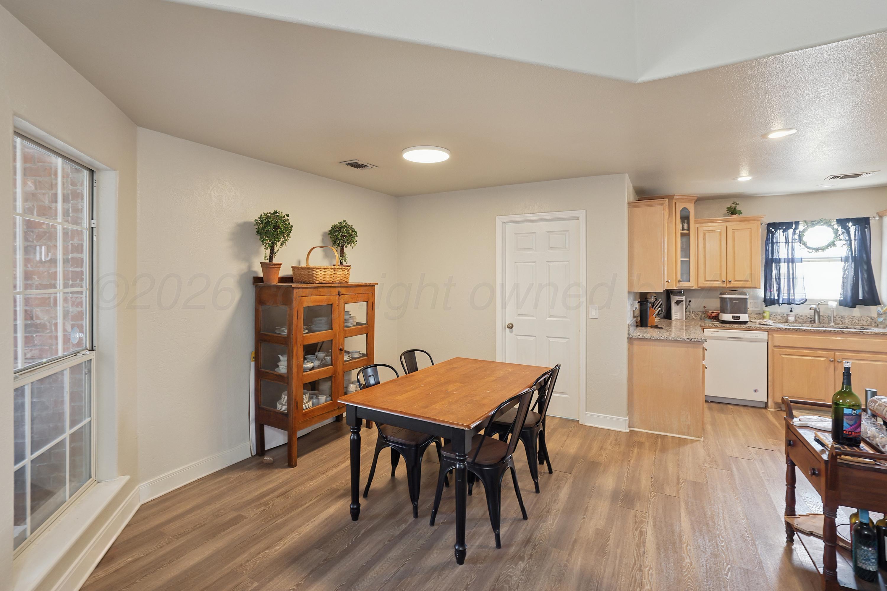 6400 Rally Road Amarillo, TX 79119 - Photo 5 of 21 a view of a dining room with furniture and wooden floor