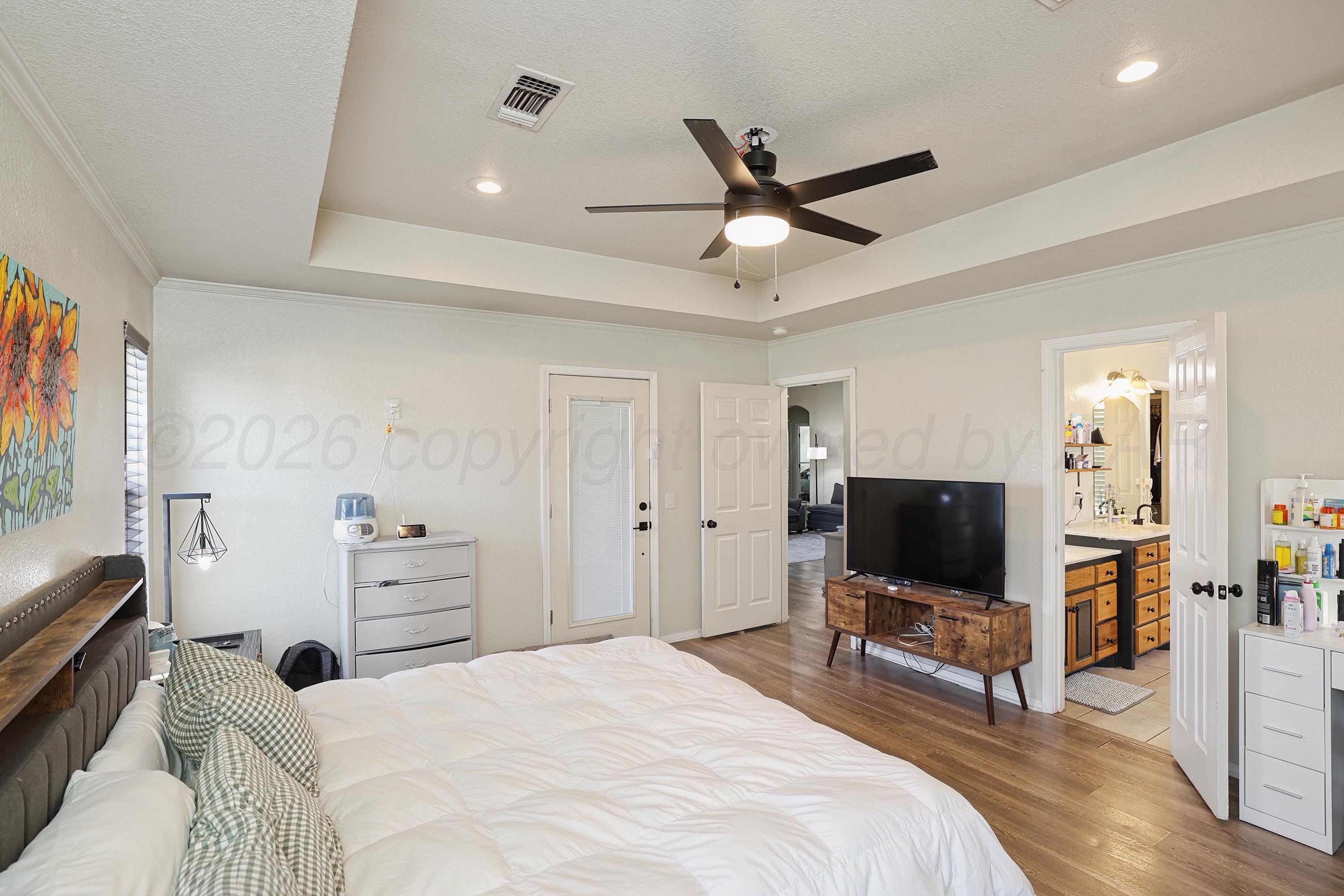 6400 Rally Road Amarillo, TX 79119 - Photo 9 of 21 a bedroom with a bed and a flat screen tv