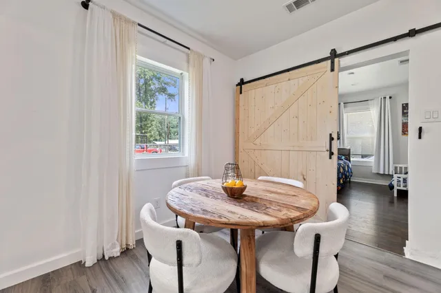 a dining room with furniture and window