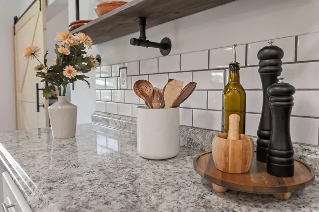 a room with painting on the wall and a wooden floor