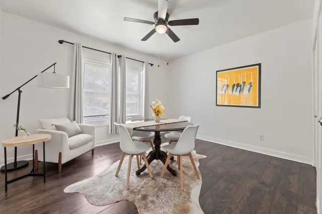 a view of a room with wooden floor and a potted plant
