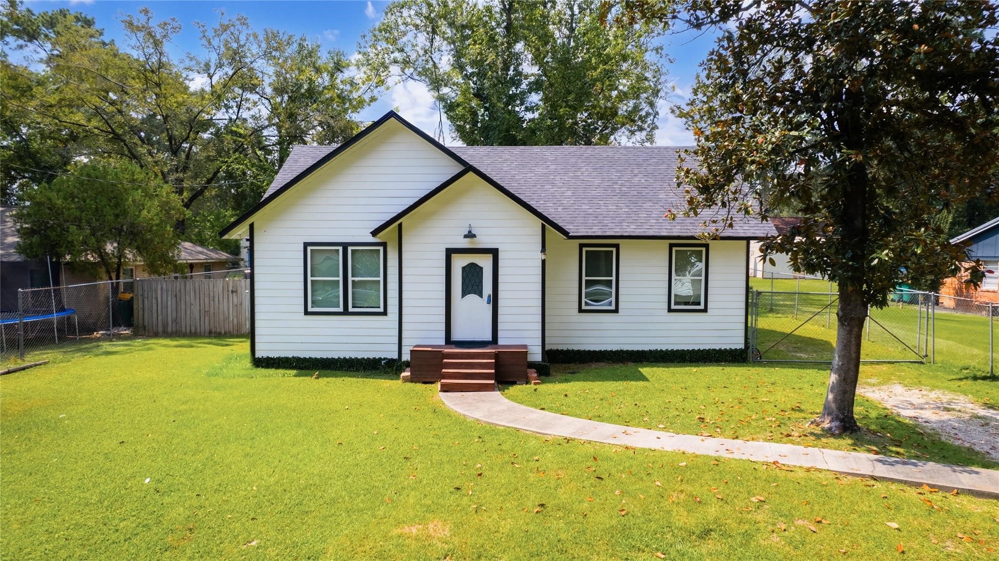 1010 Long Street Conroe, TX 77301 - Photo 2 of 26 a view of a house with a yard and tree