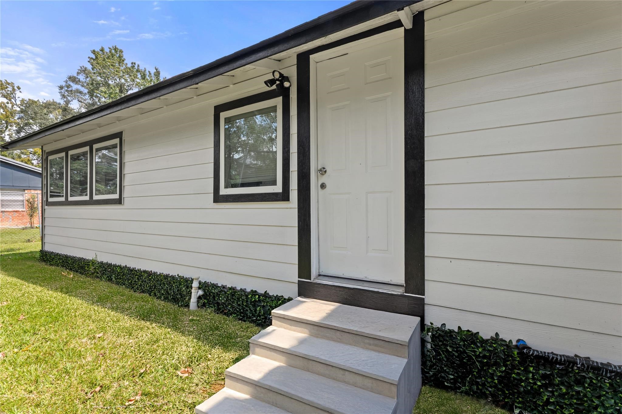 1010 Long Street Conroe, TX 77301 - Photo 23 of 26 a front view of a house with garden