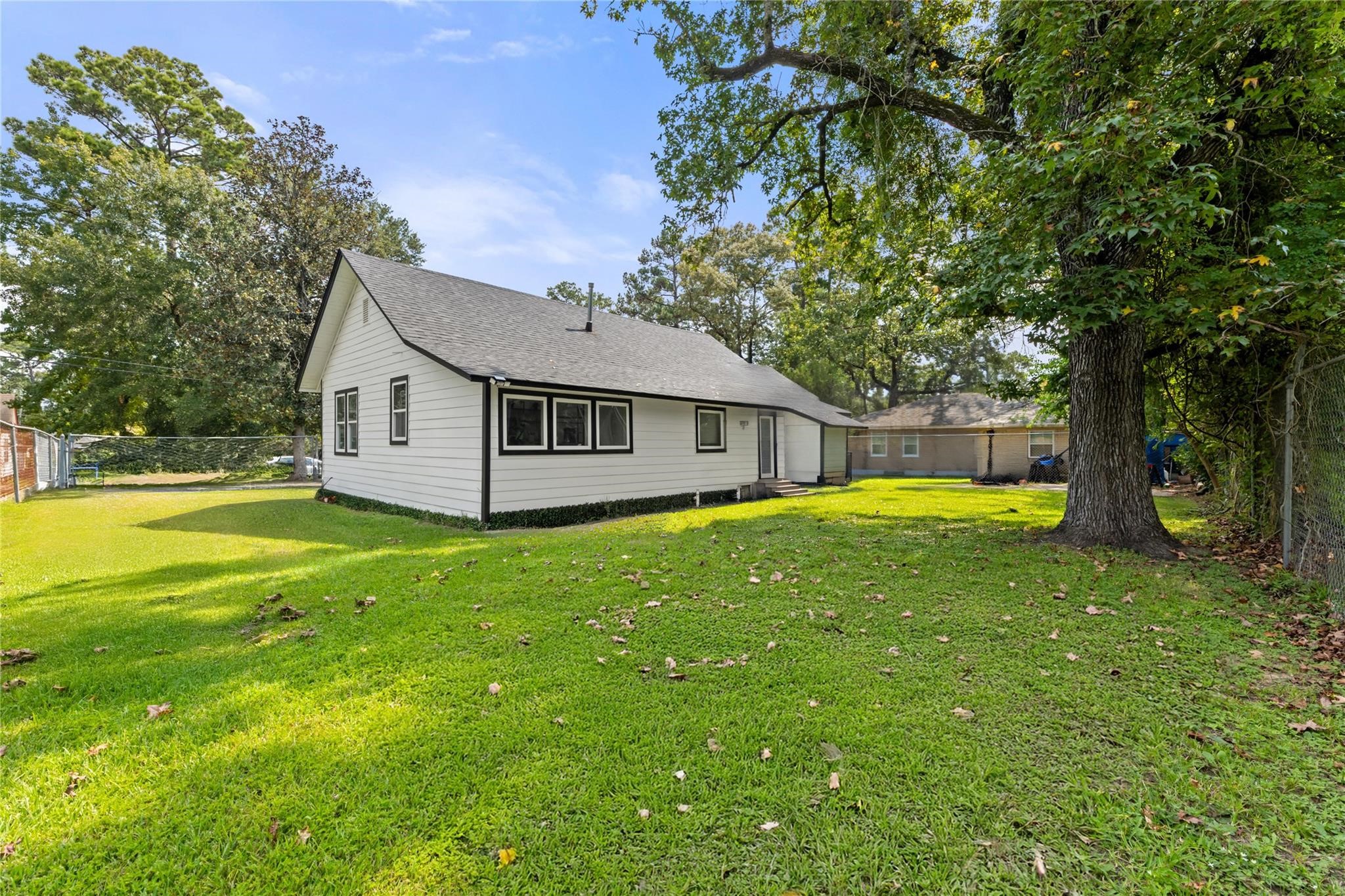 1010 Long Street Conroe, TX 77301 - Photo 24 of 26 a view of a house with a backyard