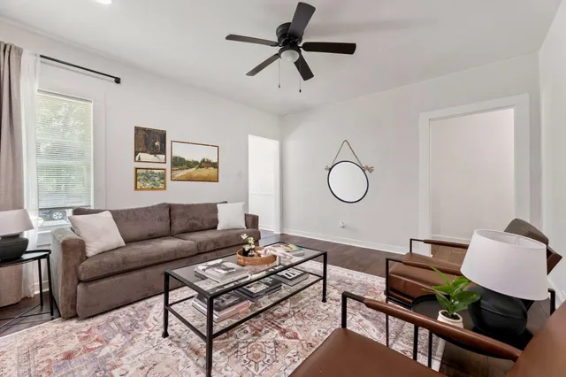 a view of a workspace area with furniture and wooden floor