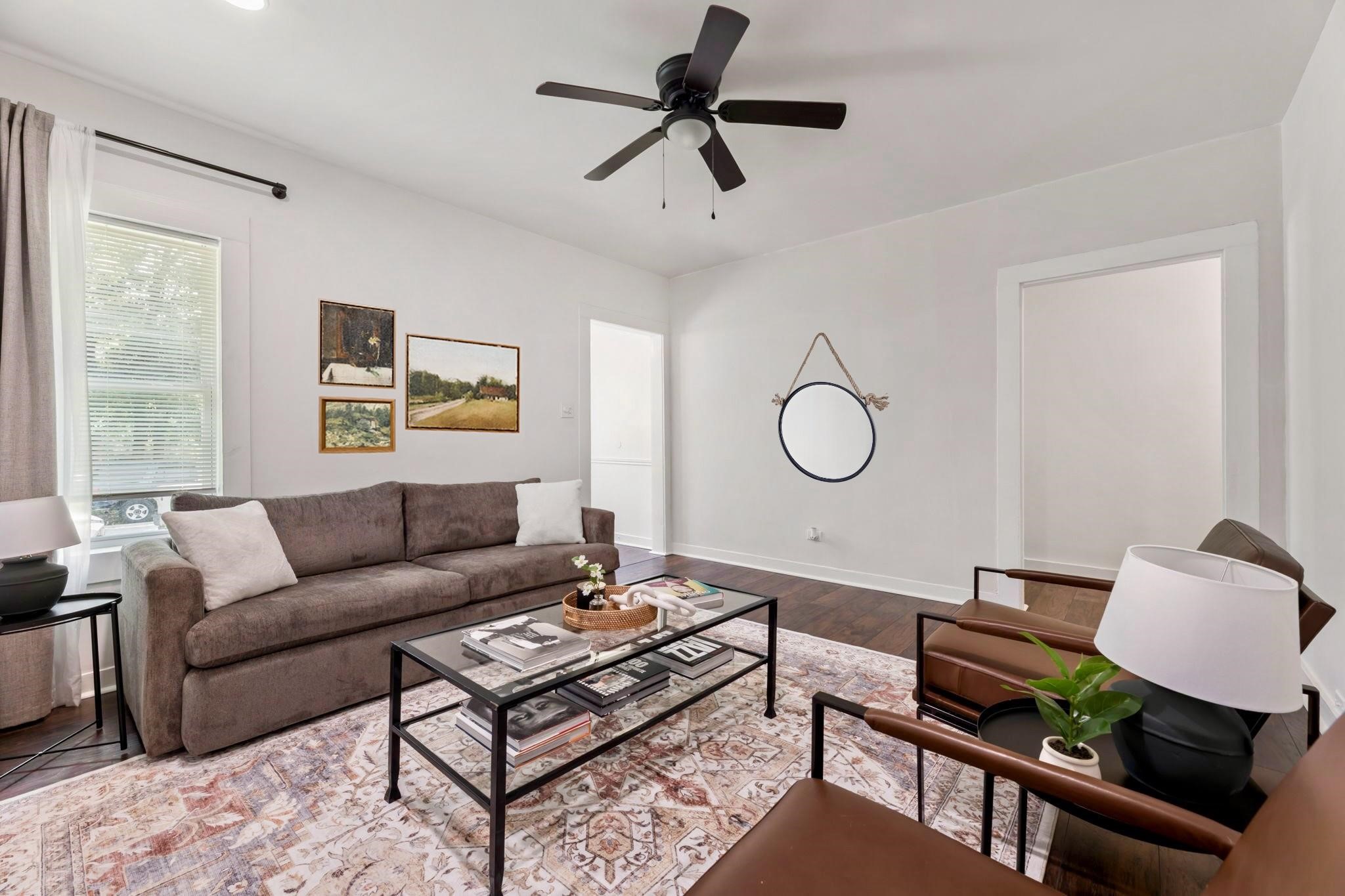 1010 Long Street Conroe, TX 77301 - Photo 5 of 26 a living room with furniture a window and a chandelier