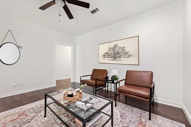 a living room with furniture a window and a chandelier