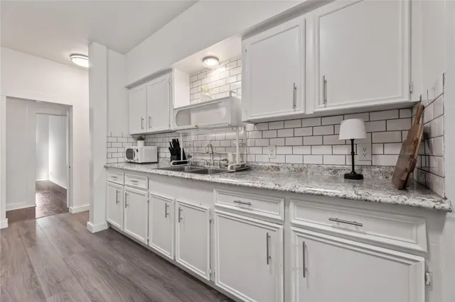 a kitchen with stainless steel appliances granite countertop a refrigerator and a sink