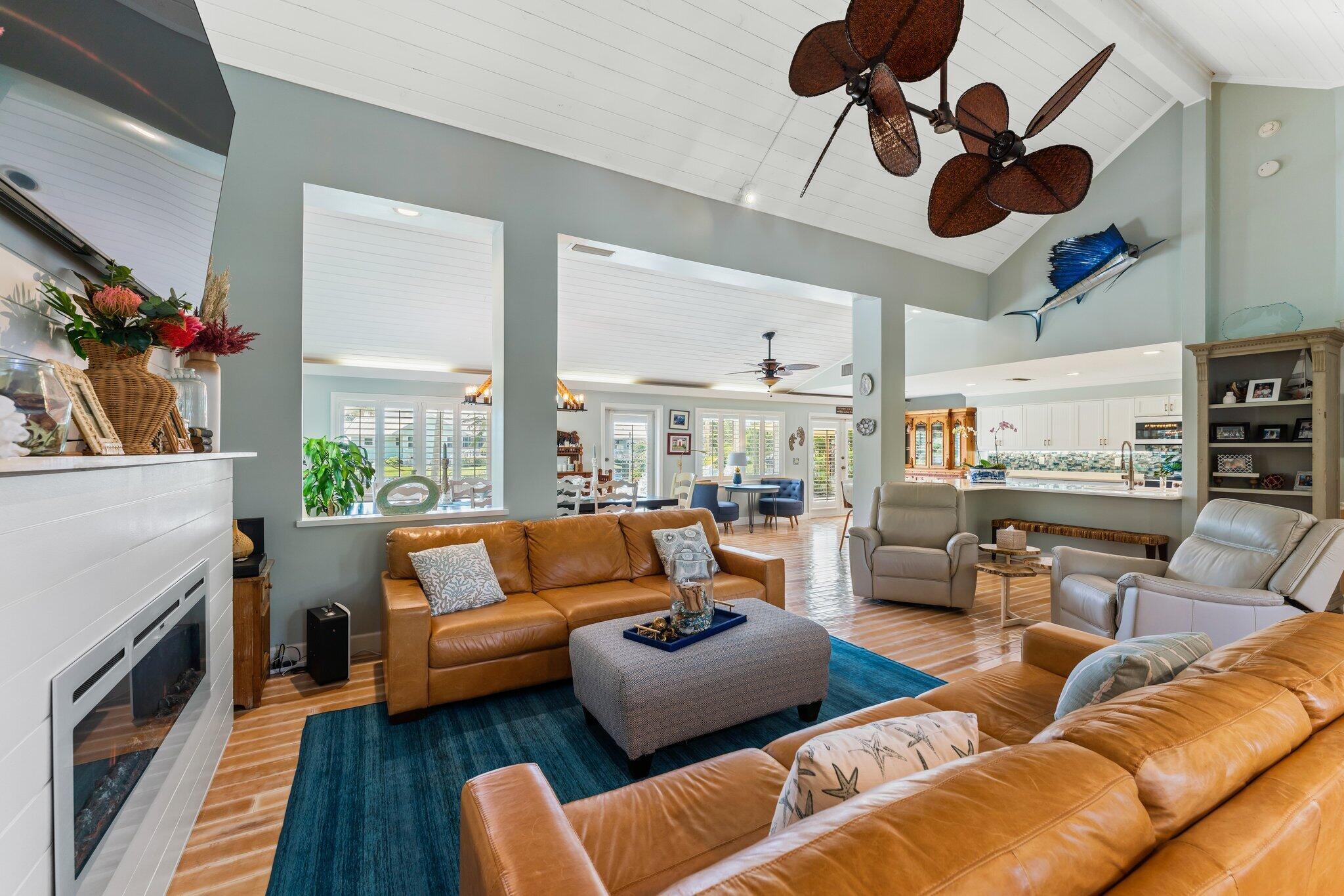 4120 Southeast Whiticar Way Stuart, FL 34997 - Photo 13 of 60 a living room with furniture kitchen view and a fireplace