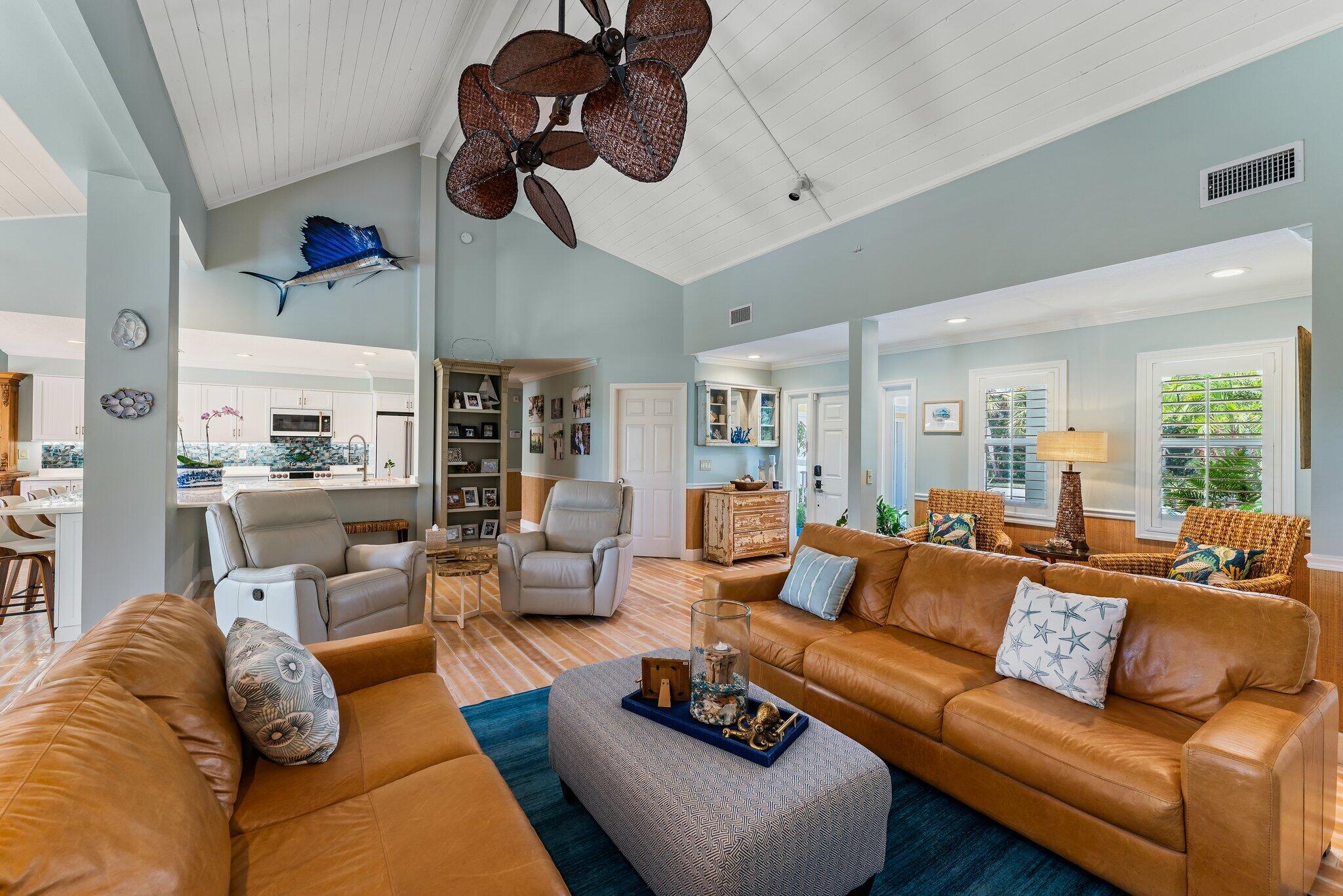 4120 Southeast Whiticar Way Stuart, FL 34997 - Photo 14 of 60 a living room with furniture kitchen view and a chandelier