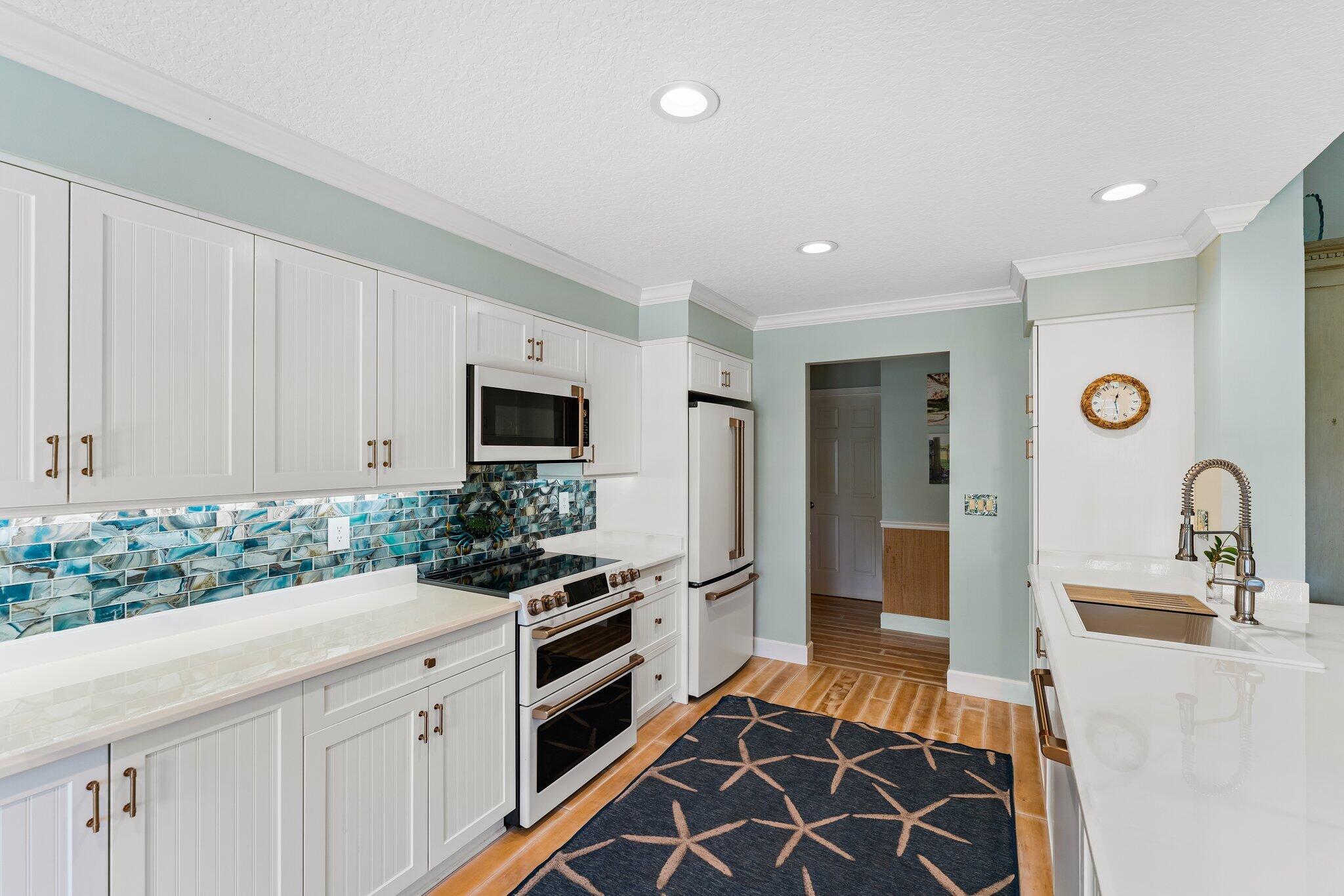 4120 Southeast Whiticar Way Stuart, FL 34997 - Photo 23 of 60 a kitchen with stainless steel appliances granite countertop a stove and a sink