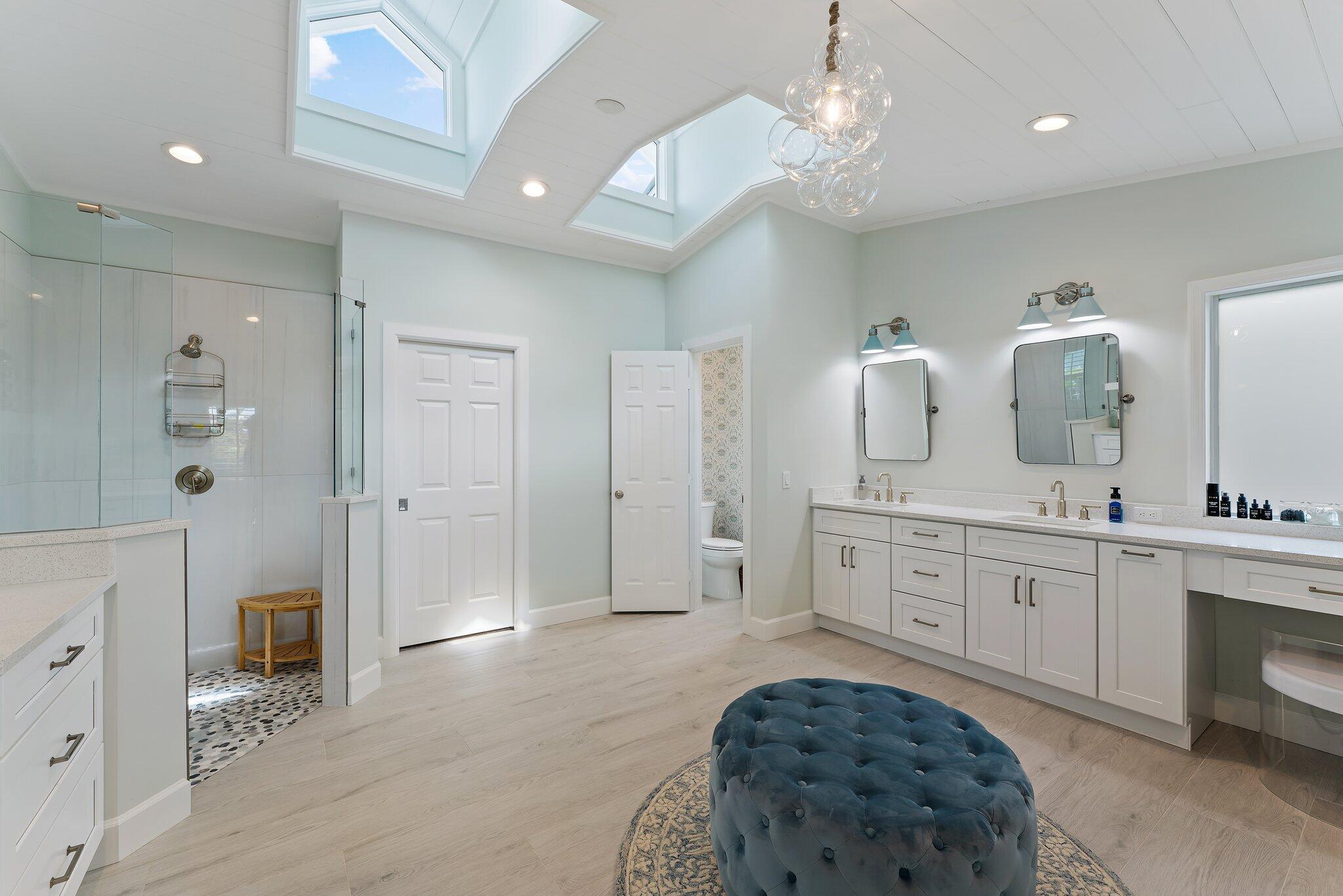 4120 Southeast Whiticar Way Stuart, FL 34997 - Photo 29 of 60 a spacious bathroom with a granite countertop sink a toilet and shower