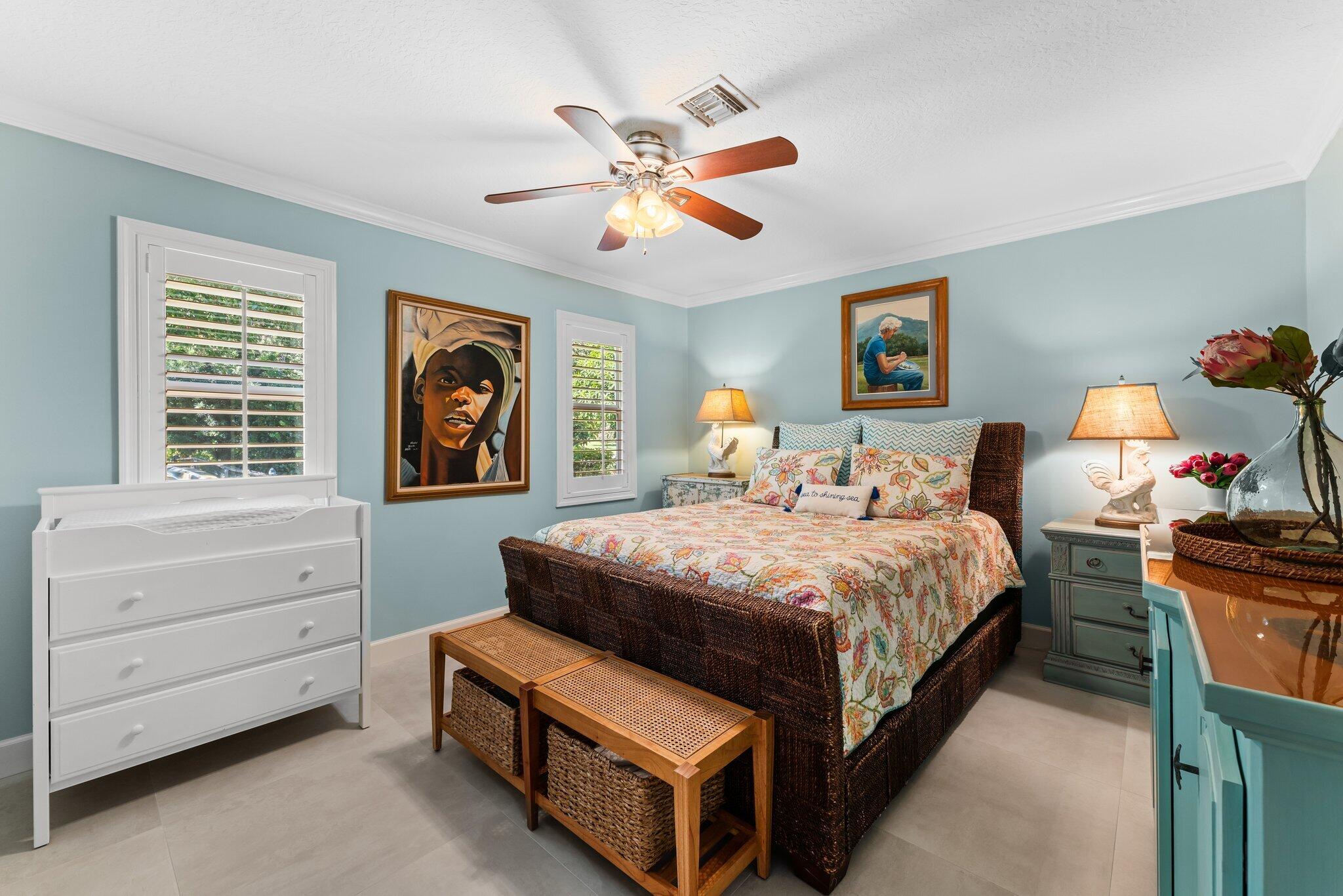 4120 Southeast Whiticar Way Stuart, FL 34997 - Photo 37 of 60 a bedroom with a bed and a dresser