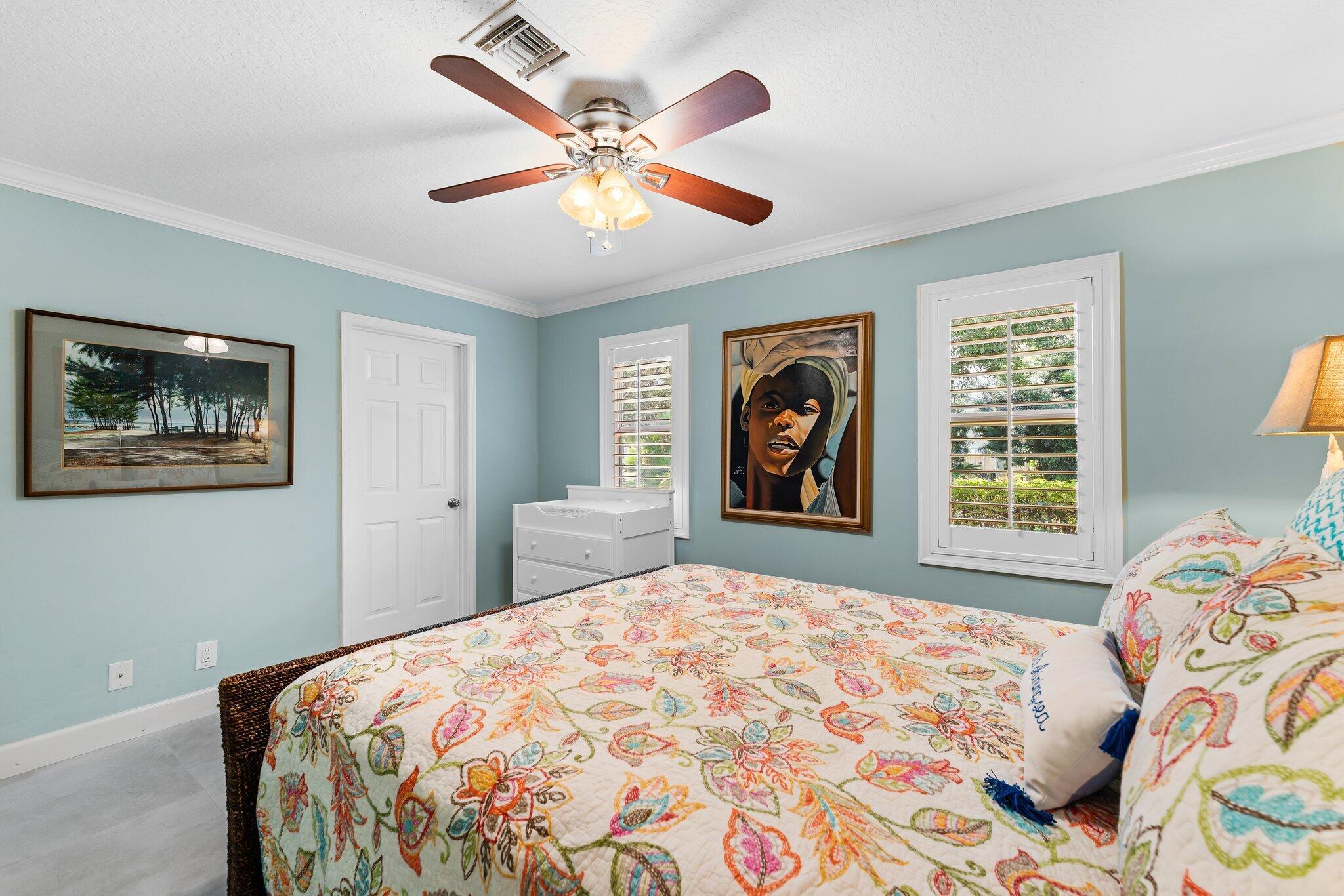 4120 Southeast Whiticar Way Stuart, FL 34997 - Photo 38 of 60 a bedroom with a large bed and a window