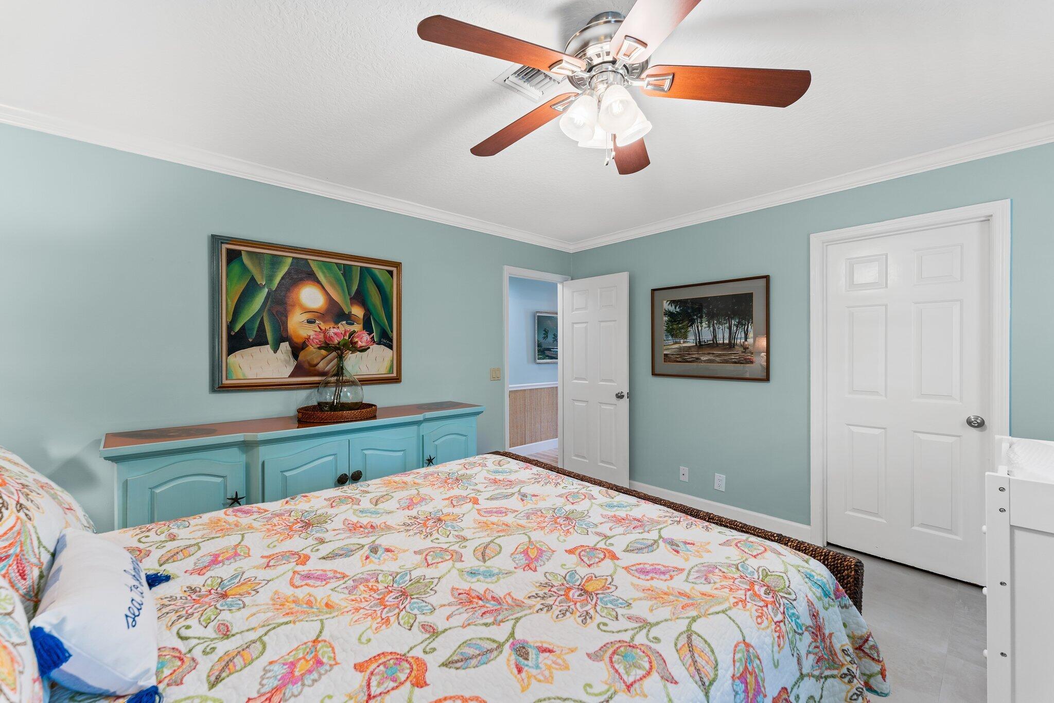 4120 Southeast Whiticar Way Stuart, FL 34997 - Photo 39 of 60 a bedroom with a bed and a chandelier