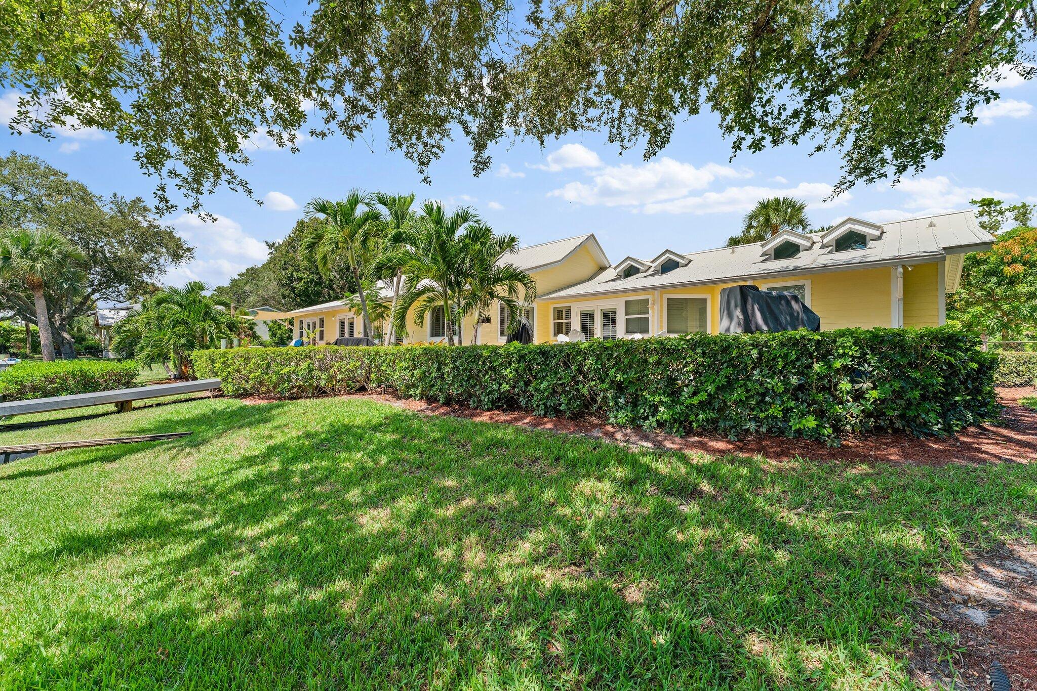 4120 Southeast Whiticar Way Stuart, FL 34997 - Photo 49 of 60 a front view of a house with a yard