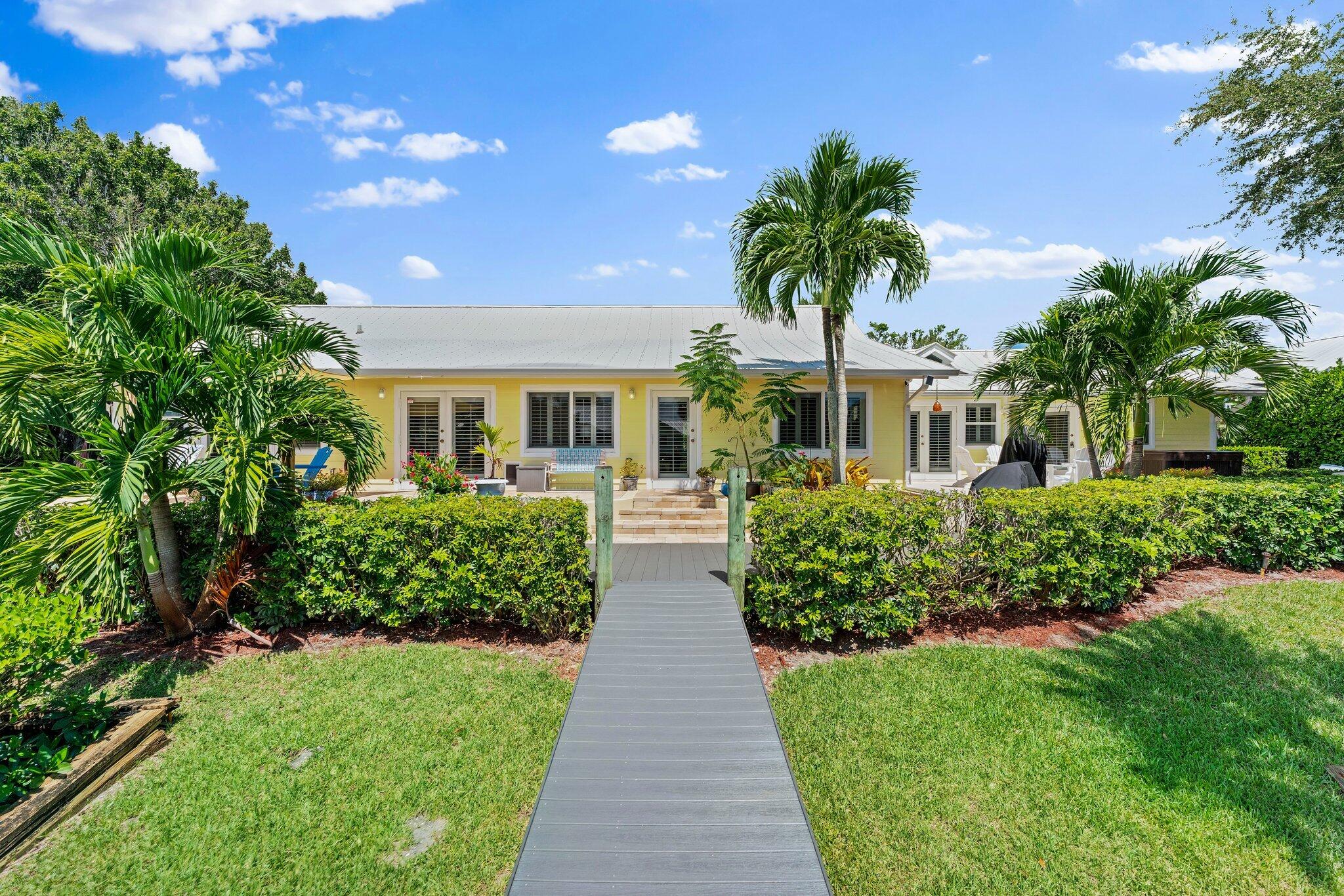 4120 Southeast Whiticar Way Stuart, FL 34997 - Photo 50 of 60 a front view of a house with a yard and fountain