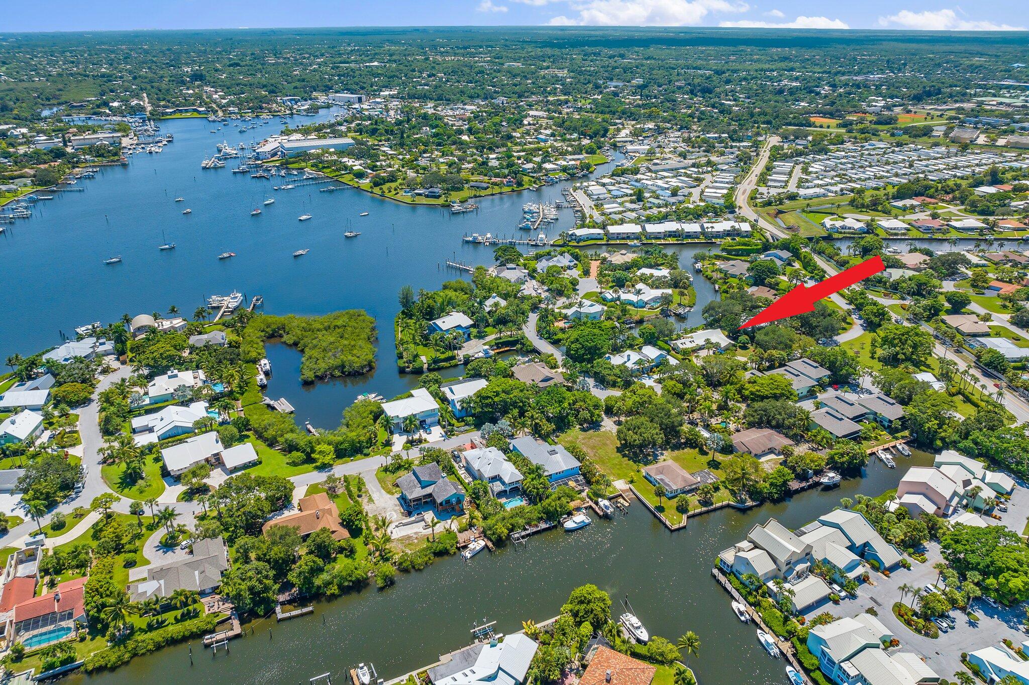 4120 Southeast Whiticar Way Stuart, FL 34997 - Photo 54 of 60 an aerial view of residential houses with outdoor space and trees