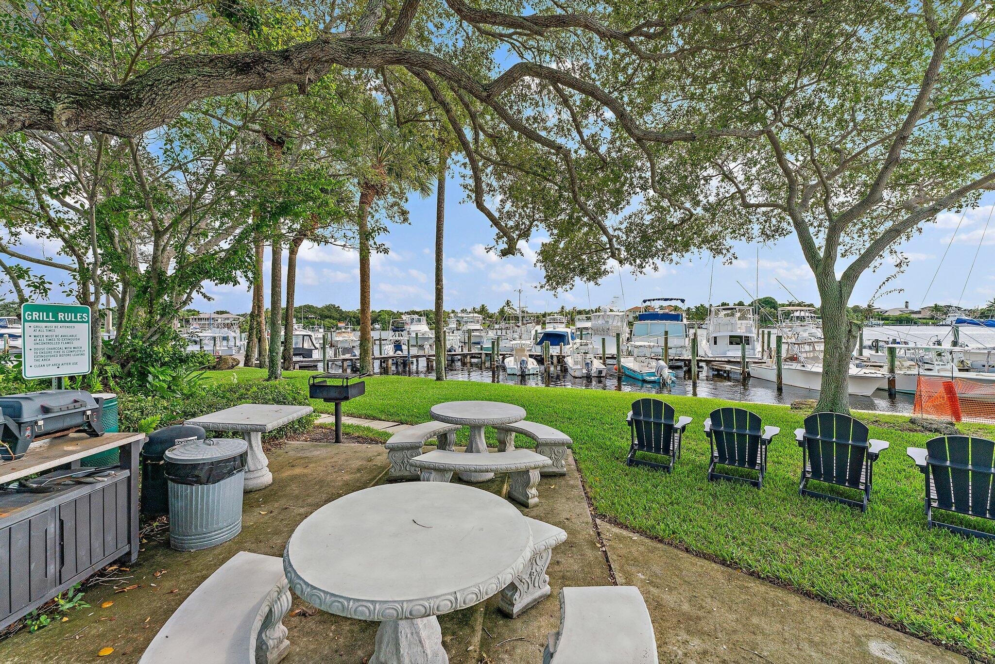 4120 Southeast Whiticar Way Stuart, FL 34997 - Photo 59 of 60 a view of a table and chairs in patio and a yard