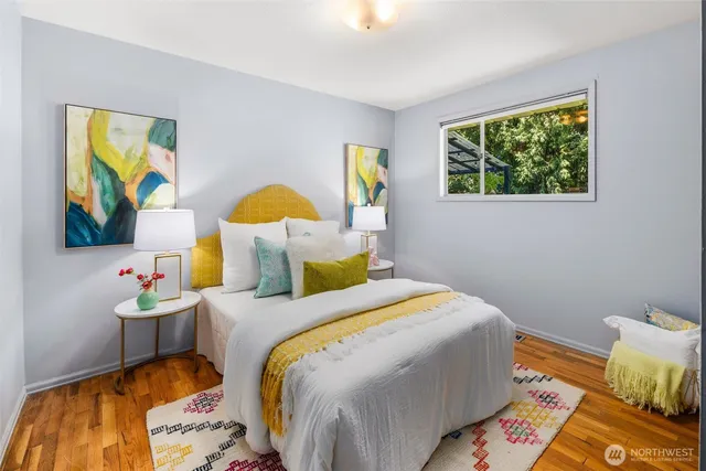 a bedroom with a bed and painting on the wall