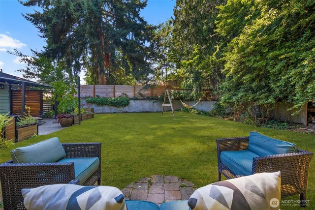 a view of backyard with seating area and green space