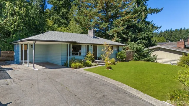 a front view of a house with a garden and porch