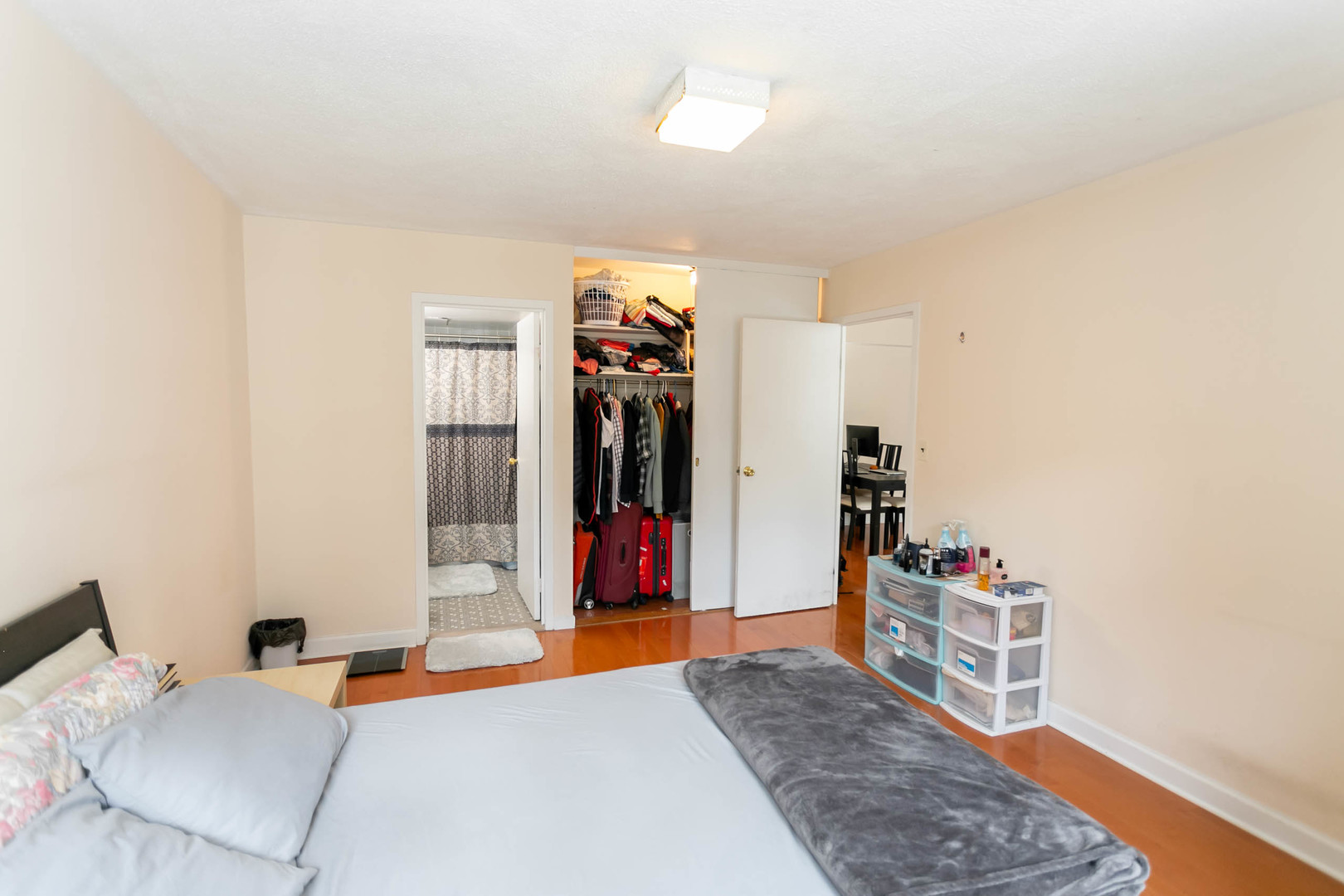 253 East Delaware Place, Unit 14C Chicago, IL 60611 - Photo 6 of 7 a bedroom with a bed and a wooden floor