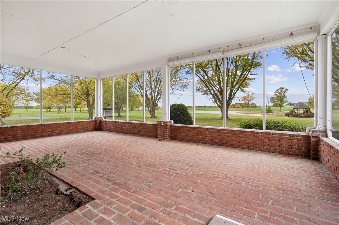 14265 Reeder Avenue Northeast Alliance, OH 44601 - Photo 18 of 39 Unfurnished sunroom with brick wall and brick floors