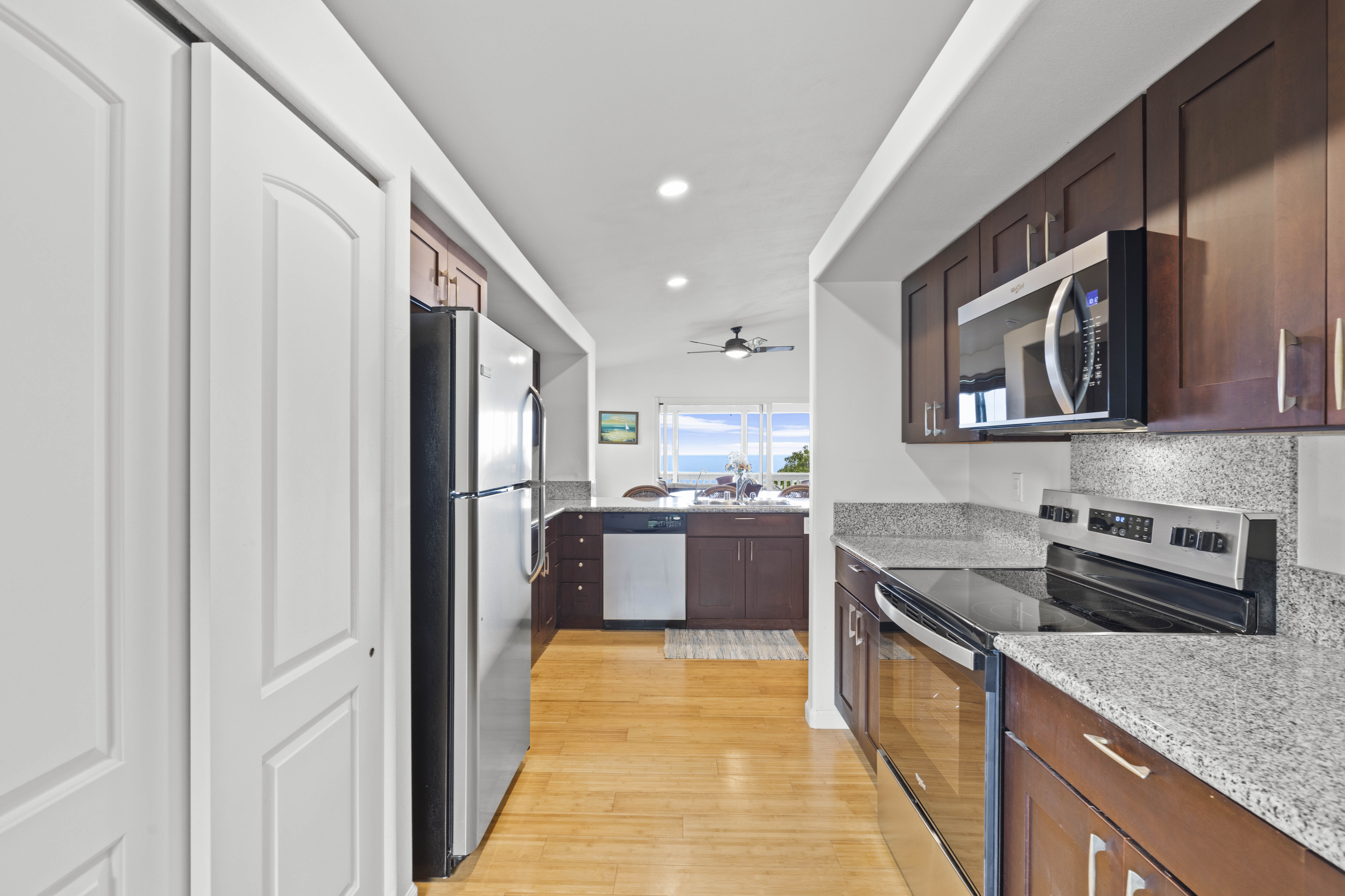 84-4955 Ke Ala O Keawe Road Captain Cook, HI 96704 - Photo 16 of 23 a kitchen with stainless steel appliances granite countertop a refrigerator and a stove top oven