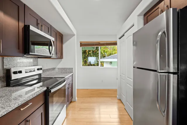 a kitchen with a refrigerator stove and microwave