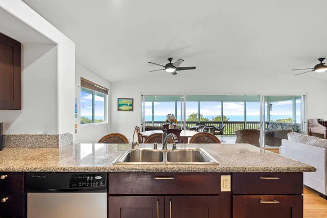 a kitchen with granite countertop a sink and cabinets
