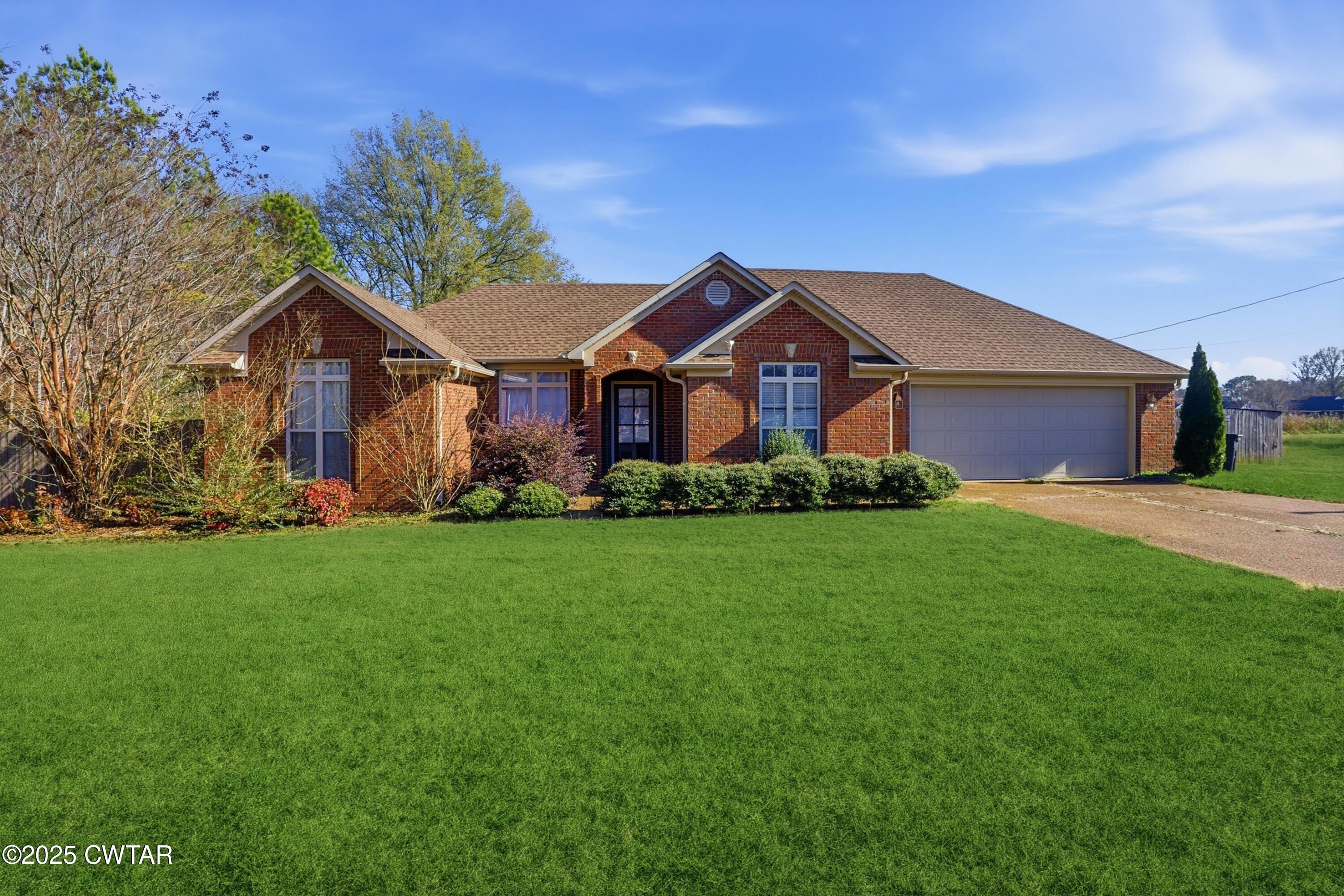 a front view of house with yard and green space