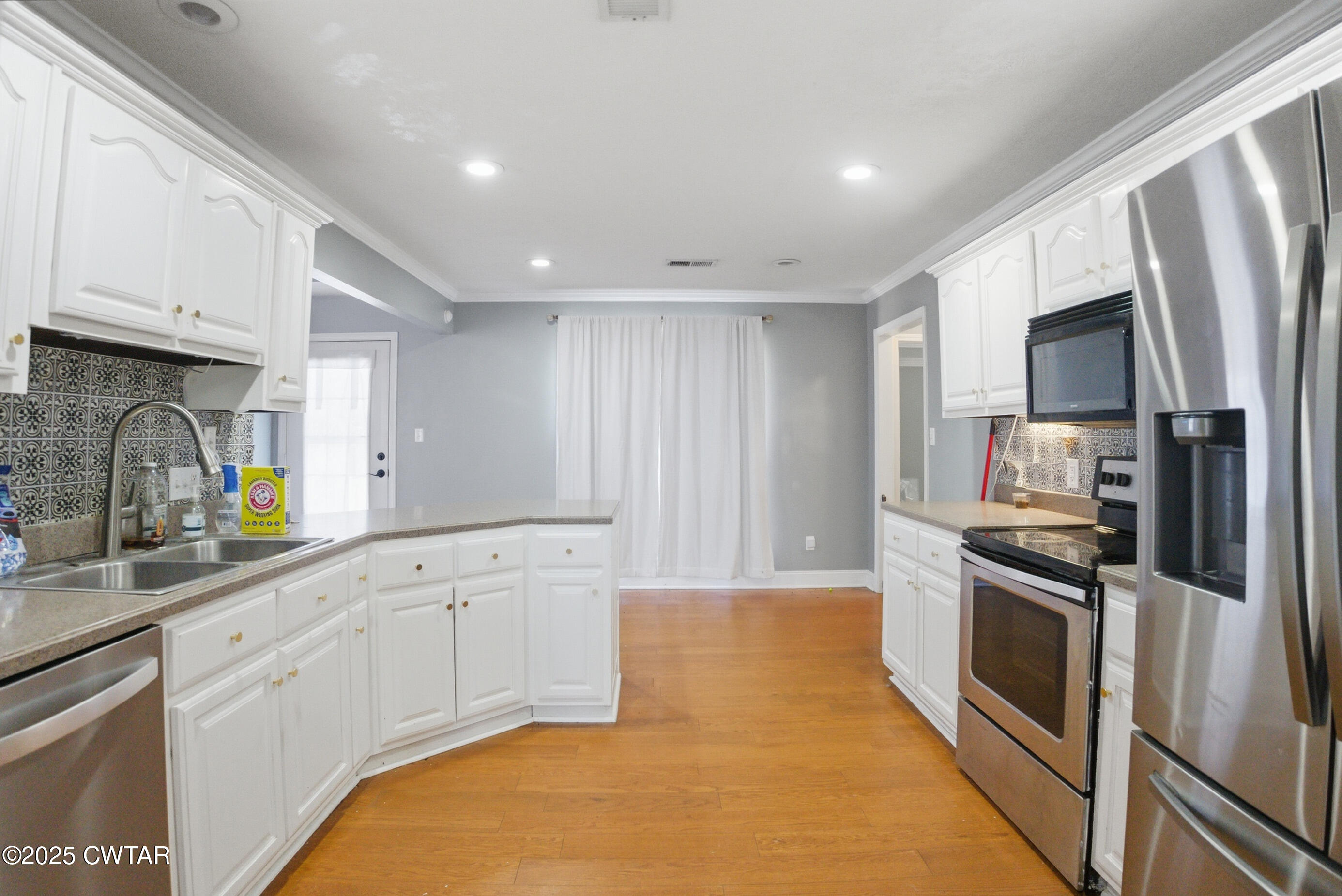766 Mason Avenue Henderson, TN 38340 - Photo 6 of 16 a kitchen with granite countertop a refrigerator stove and sink