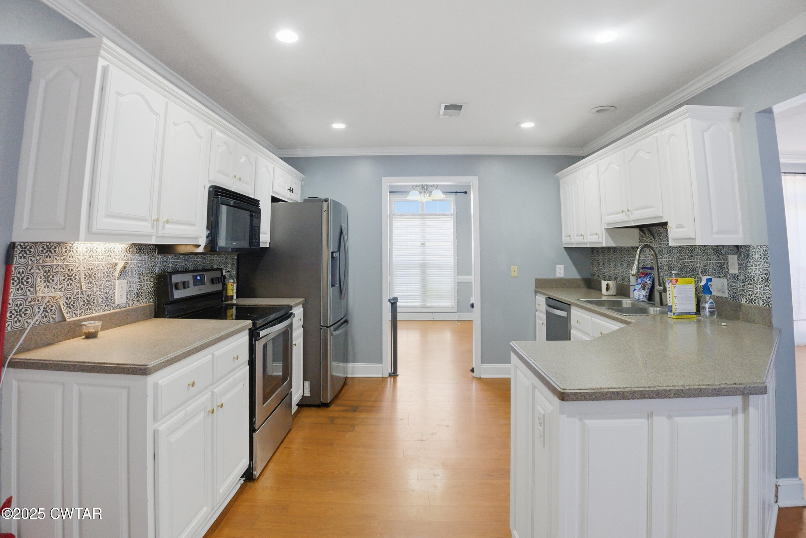766 Mason Avenue Henderson, TN 38340 - Photo 7 of 16 a kitchen with stainless steel appliances granite countertop a sink stove microwave and refrigerator