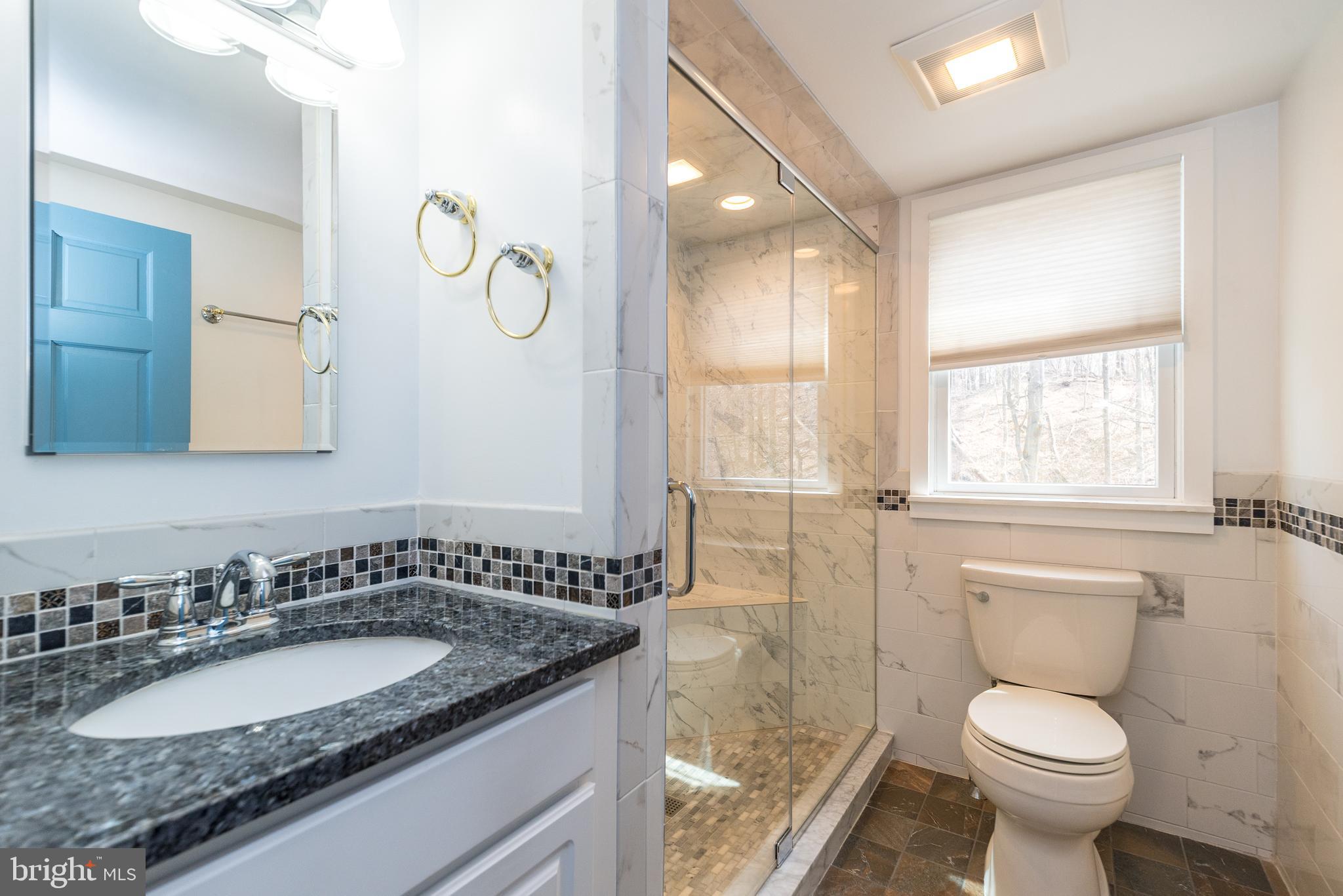 2361 Turk Road Doylestown, PA 18901 - Photo 16 of 32 a bathroom with a granite countertop toilet a sink and a mirror