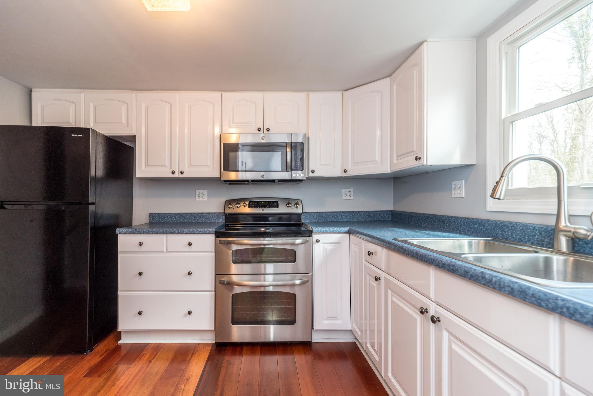 2361 Turk Road Doylestown, PA 18901 - Photo 18 of 32 a kitchen with stainless steel appliances a stove sink and refrigerator