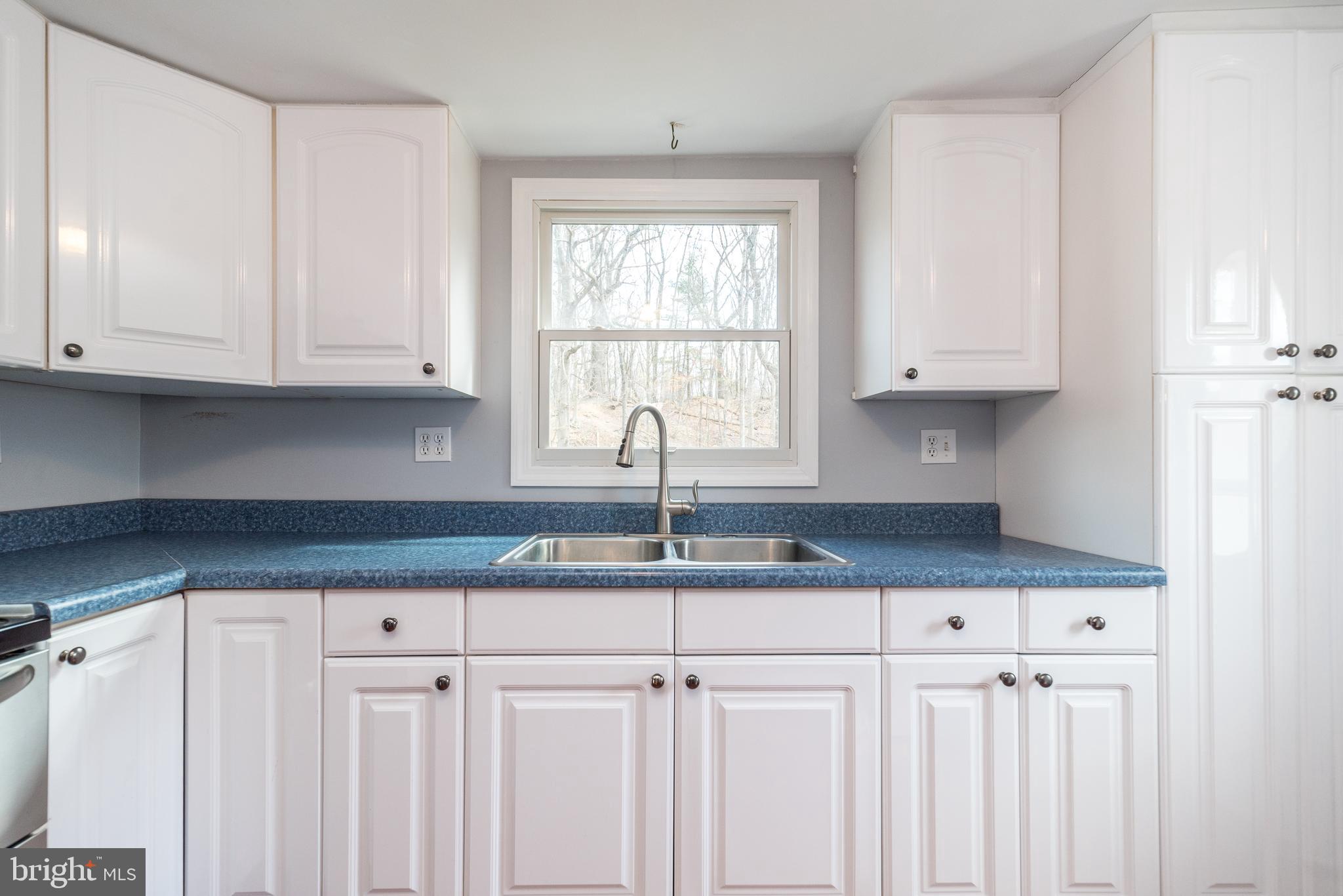 2361 Turk Road Doylestown, PA 18901 - Photo 19 of 32 a kitchen with granite countertop white cabinets and window