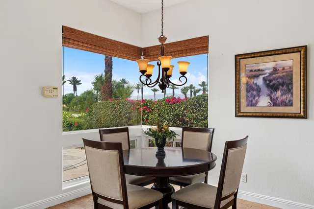 a view of a dining room with furniture and front view of a house