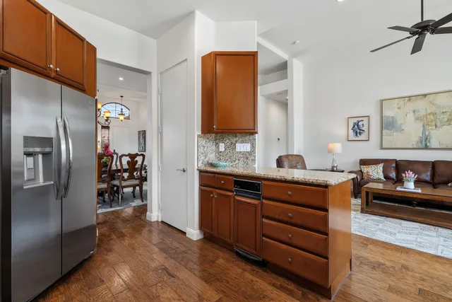 a kitchen with stainless steel appliances granite countertop a refrigerator and a sink