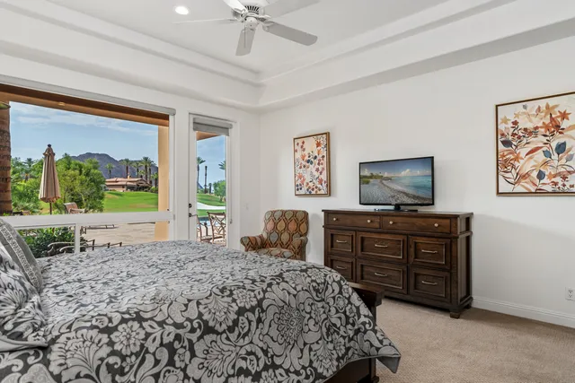 a bedroom with a bed and a flat screen television