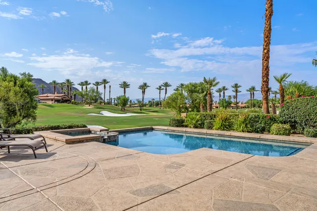 a view of a swimming pool and a yard