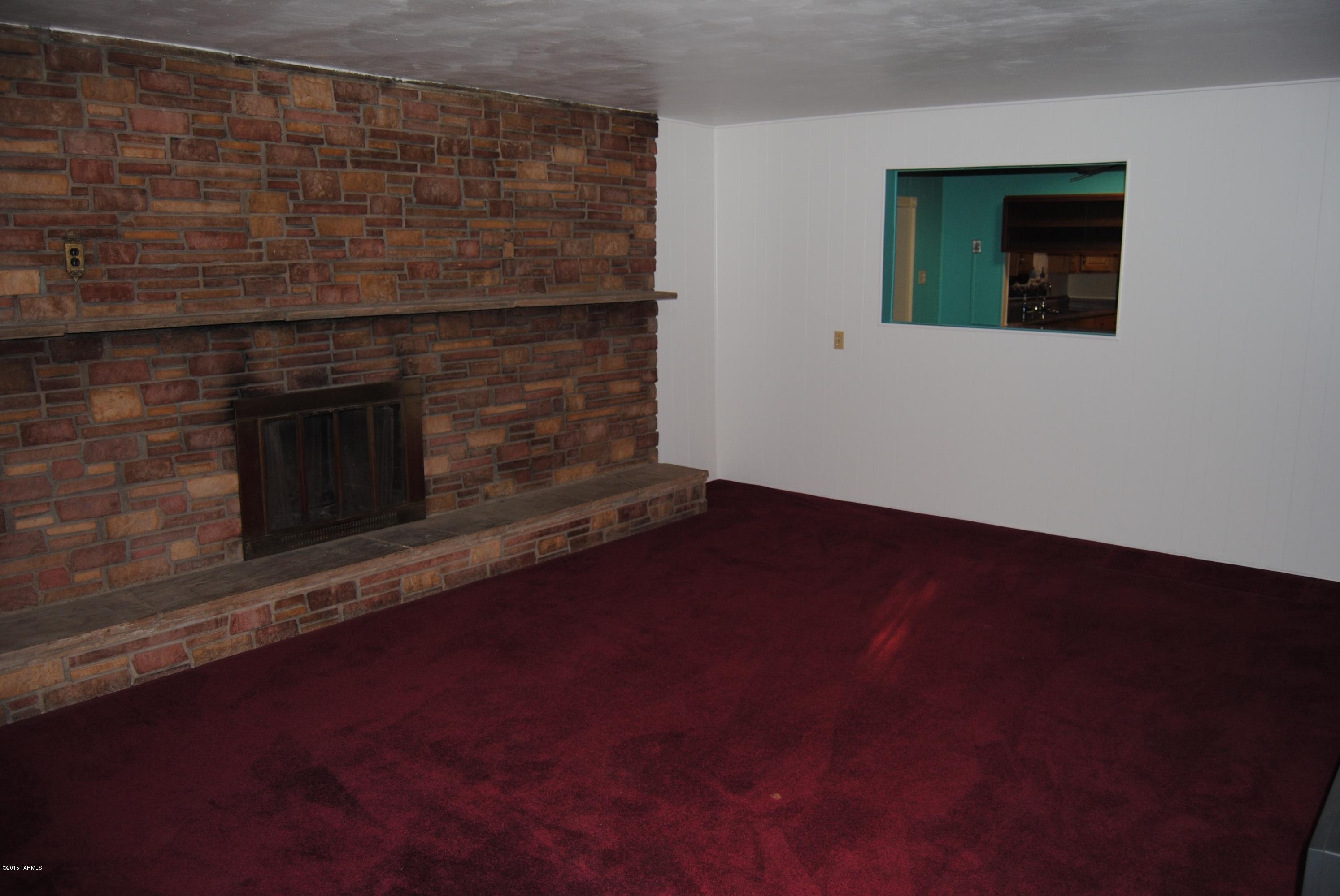 1607 West Roger Road Tucson, AZ 85705 - Photo 6 of 14 a living room with a fireplace