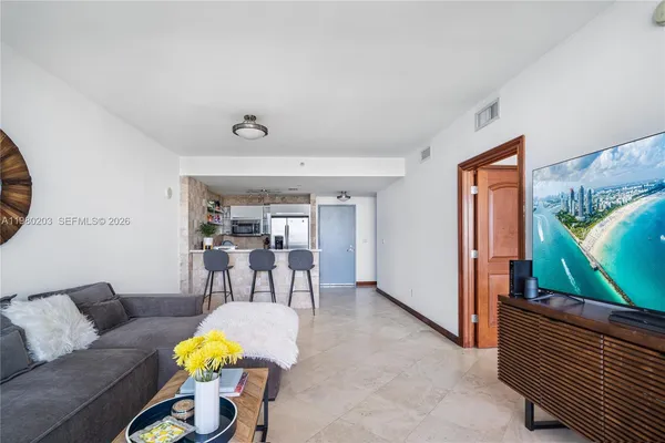 a living room with furniture and a flat screen tv